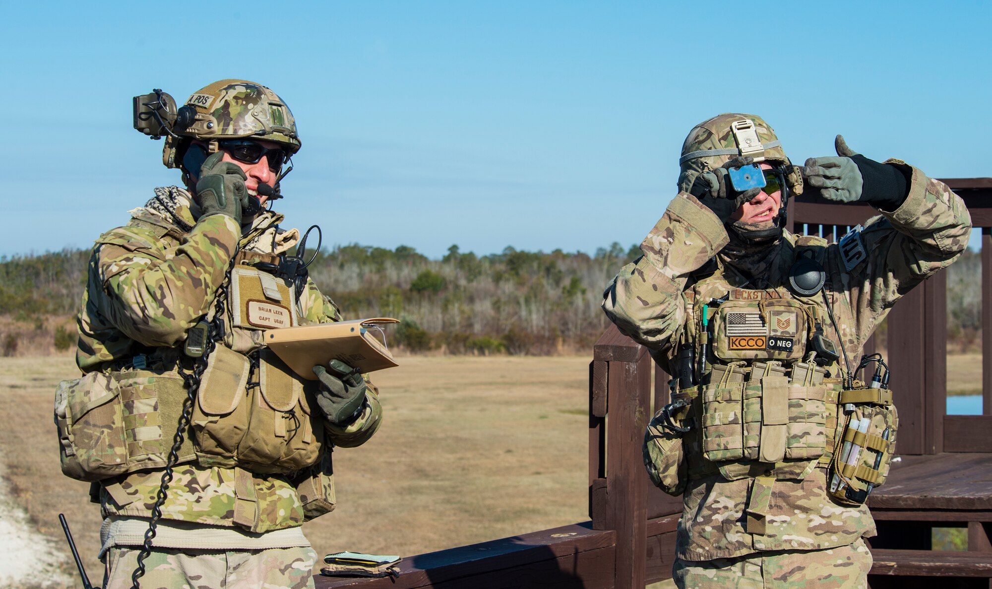 U.S. Air Force Capt. Brian Leen, 7th Air Support Operations Squadron air liaison officer, left, and Tech. Sgt. Clay Eckstrom, joint terminal attack controllers (JTAC) out of Fort Bliss, Texas, signal an A-29 Super Tucano during a light air support training Feb. 20, 2015, at Moody Air Force Base, Ga. Eckstrom used a mirror to reflect sunlight that the pilots recognize as a distress signal. (U.S. Air Force photo by Airman 1st Class Ceaira Tinsley/Released)