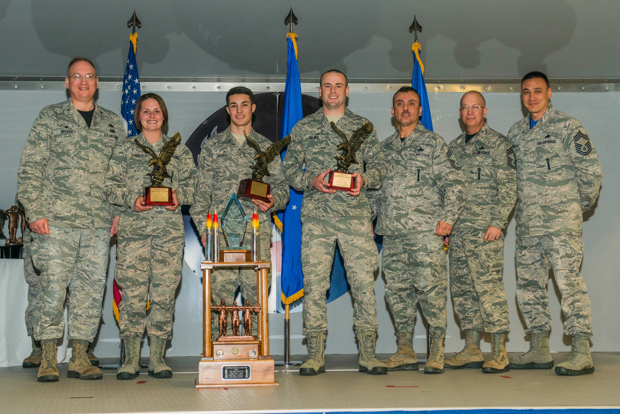 Airmen from the 75th Aircraft Maintenance Unit receive the A-10C Thunderbolt II Load Crew of the Year award during the 2015 Maintenance Professional of the Year awards ceremony Feb. 20, 2015, at Moody Air Force Base, Ga. The load crew members, U.S. Air Force Airmen 1st Class Alec Lamarca and Kyle Palmer, 75th AMU load crew members, and Staff Sgt. Cecil Loges, 75th AMU load crew chief, were recognized for their work ethic in 2014. (U.S. Air Force photo by Airman 1st Class Dillian Bamman/Released)