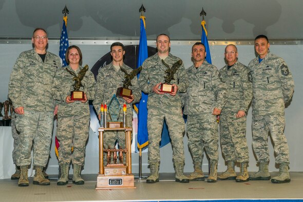 Airmen from the 75th Aircraft Maintenance Unit receive the A-10C Thunderbolt II Load Crew of the Year award during the 2015 Maintenance Professional of the Year awards ceremony Feb. 20, 2015, at Moody Air Force Base, Ga. The load crew members, U.S. Air Force Airmen 1st Class Alec Lamarca and Kyle Palmer, 75th AMU load crew members, and Staff Sgt. Cecil Loges, 75th AMU load crew chief, were recognized for their work ethic in 2014. (U.S. Air Force photo by Airman 1st Class Dillian Bamman/Released)