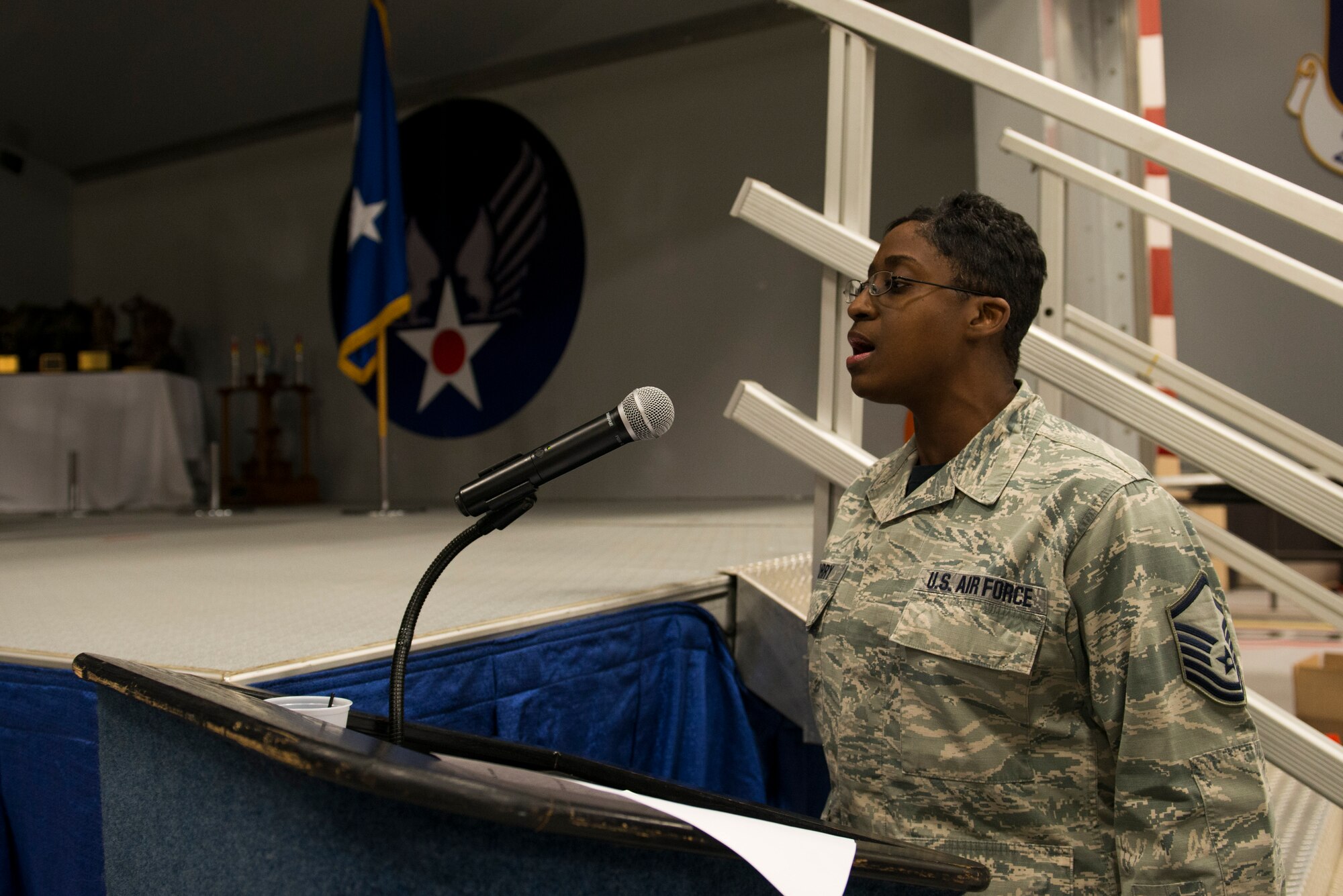 U.S. Air Force Master Sgt. Sheryl Curry, 23d Maintenance Group functional manager, sings the U.S. National Anthem during the 2015 Maintenance Professional of the Year awards ceremony Feb. 20, 2015, at Moody Air Force Base, Ga. Before the ceremony, each maintenance Airmen nominated for an award received a medallion from the 23d MXG commander Col. Jeffrey Decker. (U.S. Air Force photo by Airman 1st Class Dillian Bamman/Released)