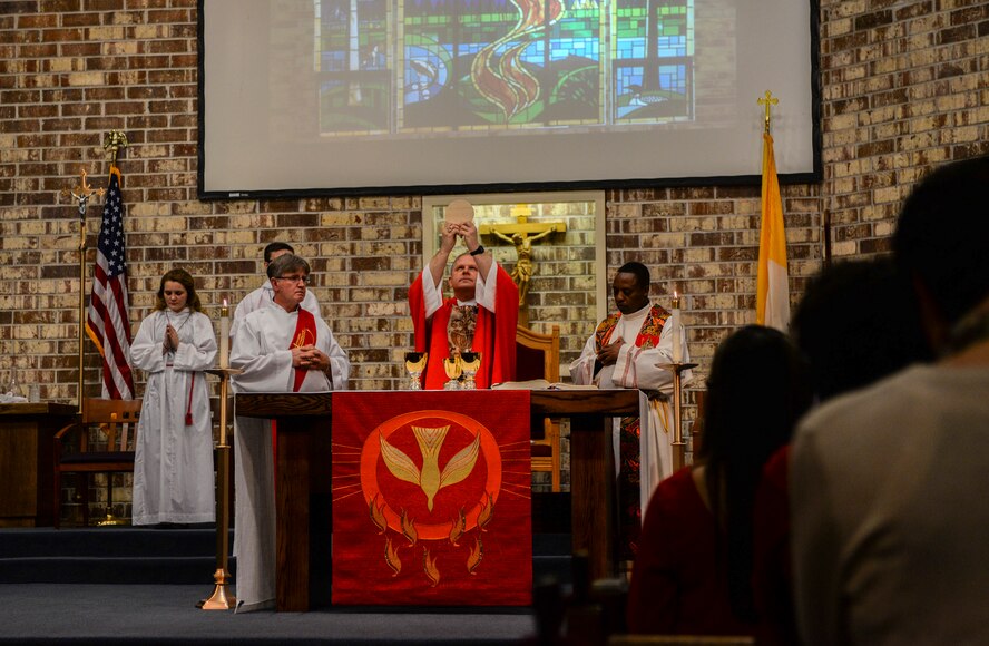 Bishop Robert J. Coyle, auxiliary bishop for the Archdiocese for the Military Services, performs the Prayer of Consecration during Confirmation Mass, Feb. 17, 2015, at Moody Air Force Base, Ga. Coyle served in the Navy for more than 24 years on active and reserve duty before retiring in 2013. (U.S. Air Force photo by Senior Airman Sandra Marrero/Released)
