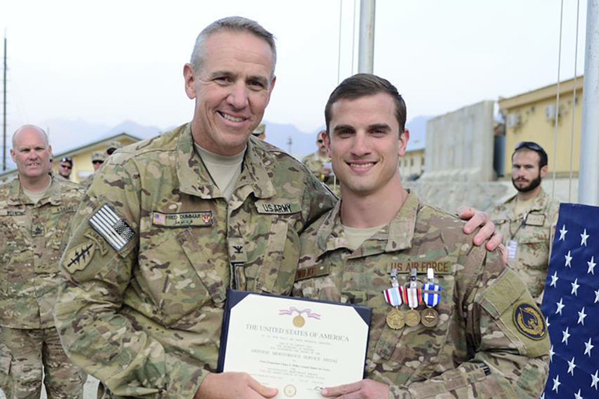 U.S. Army Col. Frederick Dummar, Afghan National Army Special Operations Command - Special Operations Advisory Group commander, presents 1st Lt. Chase S. Wilke, ANASOC-SOAG contracting advisor, and Battle Management Directorate’s Aerospace Management Systems Branch contracting officer, with the Defense Meritorious Service Medal, Afghanistan Campaign Medal, and Non-Article 5 NATO Medal for International Security Assistance Force last year near the end of his deployment to Afghanistan. Wilke and other contracting officers at Hanscom AFB have provided a critical capability to the warfighting mission since Operations Enduring and Iraqi Freedom began more than a decade ago. (Courtesy photo)