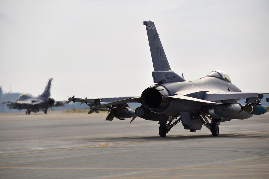 F-16s from Homestead Air Reserve Base, Fla., taxi to the runway at Eglin Air Force Base, Fla., in support of Combat Hammer, a weapons system evaluation program used to determine the validity of munitions products and processes, March 18 through 22, 2013. Combat Archer focuses on the air-to-air weapons systems, where Combat Hammer focuses on air-to-ground systems. (U.S. Air Force photo/Tech. Sgt. Lou Burton)