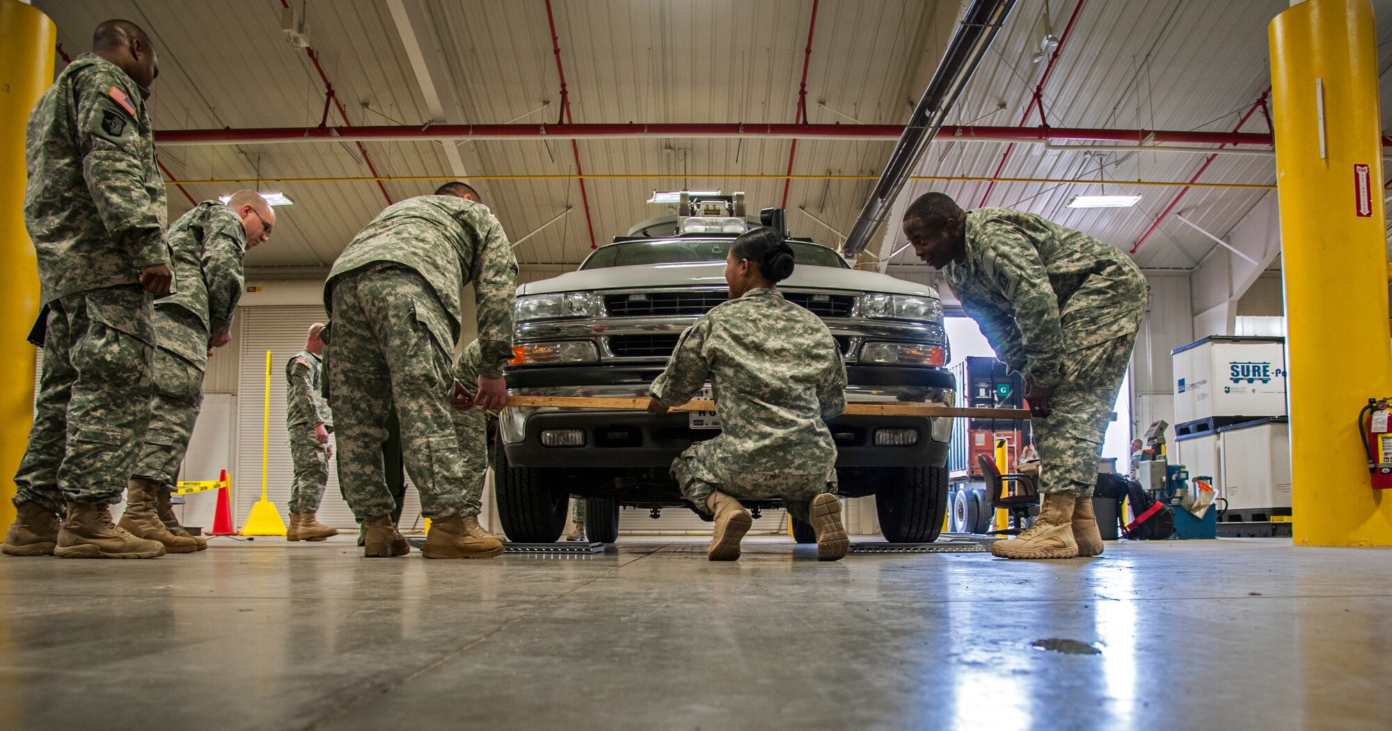 Joint Base McGuire-Dix-Lakehurst mobility specialists measure the front end of a sport utility vehicle   during a joint exercise at Joint Base McGuire-Dix-Lakehurst, N.J., Feb. 12, 2015. The specialists comprised of Army, Air Force and Federal Emergency Management Agency personnel came together to review policies and practices in the event airlift is needed to support a national emergency or crisis. (U.S. Air Force photo by Staff Sgt. Scott Saldukas/Released)