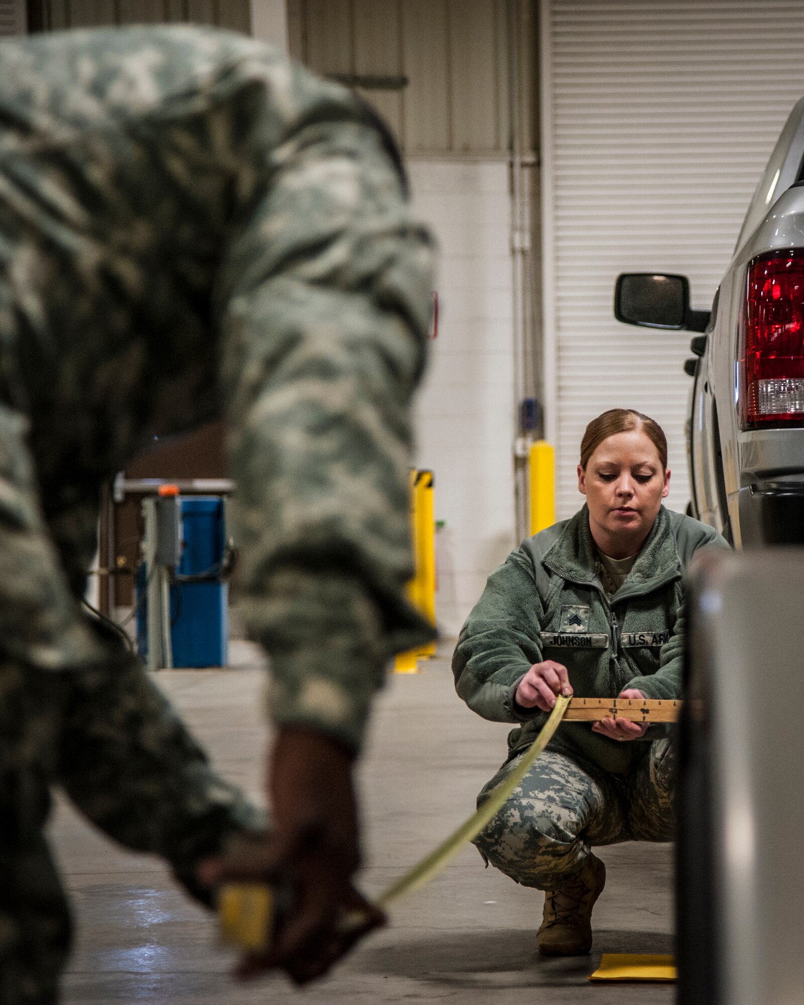 Army Sgt. Amber Johnson, Federal Emergency Management Agency, measures the length of a trailer during a joint exercise at Joint Base McGuire-Dix-Lakehurst, N.J., Feb. 12, 2015. Mobility specialists comprised of Army, Air Force and FEMA personnel came together to review policies and practices in the event airlift is needed to support a national emergency or crisis. (U.S. Air Force photo by Staff Sgt. Scott Saldukas/Released)