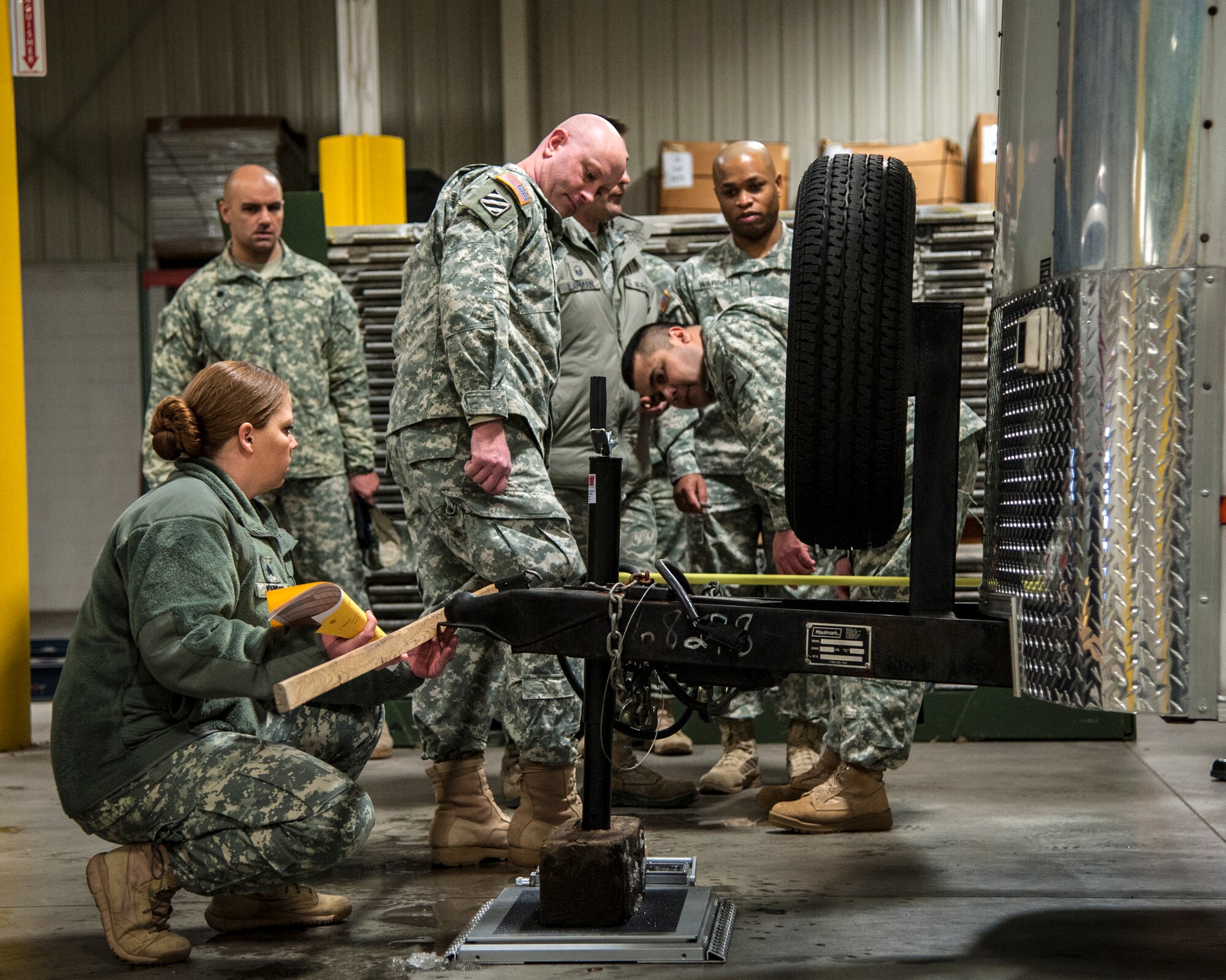 Army Sgt. Amber Johnson, Federal Emergency Management Agency, documents the length of a trailer during a joint exercise at Joint Base McGuire-Dix-Lakehurst, N.J., Feb. 12, 2015. Mobility specialists comprised of Army, Air Force and FEMA personnel came together to review policies and practices in the event airlift is needed to support a national emergency or crisis. (U.S. Air Force photo by Staff Sgt. Scott Saldukas/Released)