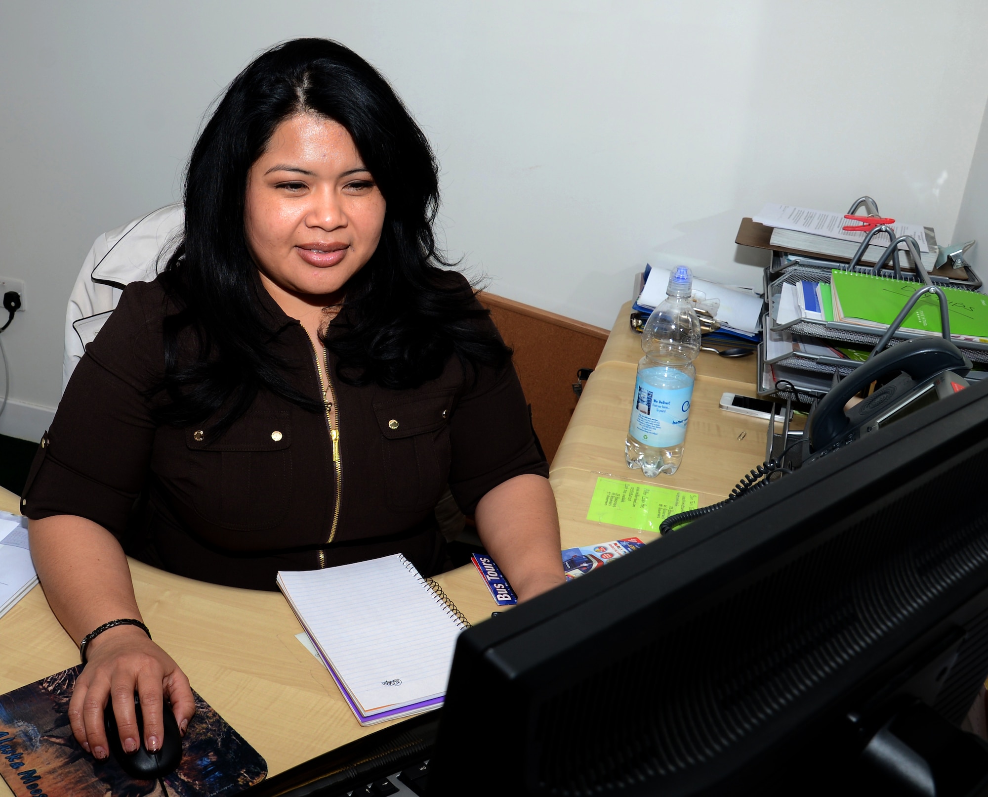 Dana Collins, 100th Force Support Squadron Information, Tickets and Travel sales clerk from Panama City, Fla., researches a vacation destination for a customer Feb. 23, 2015, on RAF Mildenhall, England. The ITT serves all Department of Defense personnel, including active duty military and family members. The ITT moved location to share Bldg. 162 with outdoor recreation in order to better serve customers under one roof. (U.S. Air Force photo by Gina Randall/Released)