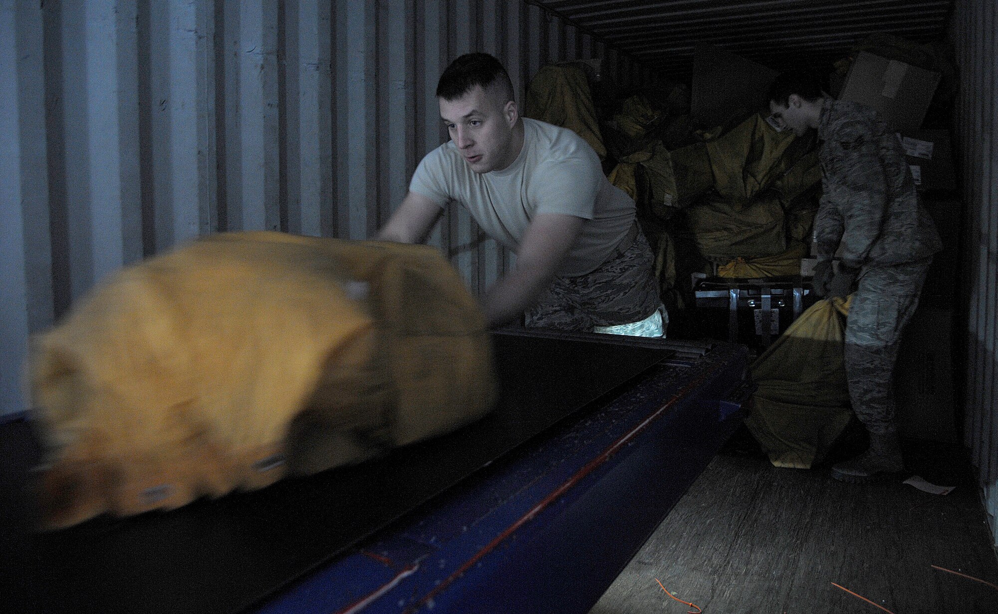 Senior Airmen Adam Beat (left) and Zachary Herick, 86th Communications Squadron postal specialists, unload mail from a truck Feb. 19, 2015. The 86th CS postal specialists serve all members of the Kaiserslautern Military Community. The Northside Post Office handles approximately eight millions pounds of mail annually. (U.S. Air Force photo/Senior Airman Timothy Moore)