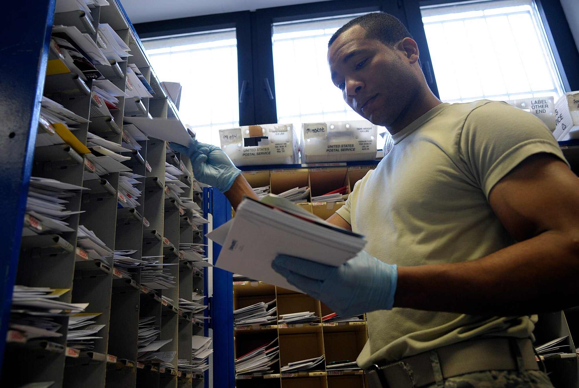 Staff Sgt. James Whyte, 86th Communications Squadron postal specialist, sorts mail in the Northside Post Office Feb. 13, 2015 at Ramstein Air Base, Germany. The Northside Post Office is the largest Department of Defense postal operation, handling approximately eight million pounds of mail annually. (U.S. Air Force photo/Senior Airman Timothy Moore)
