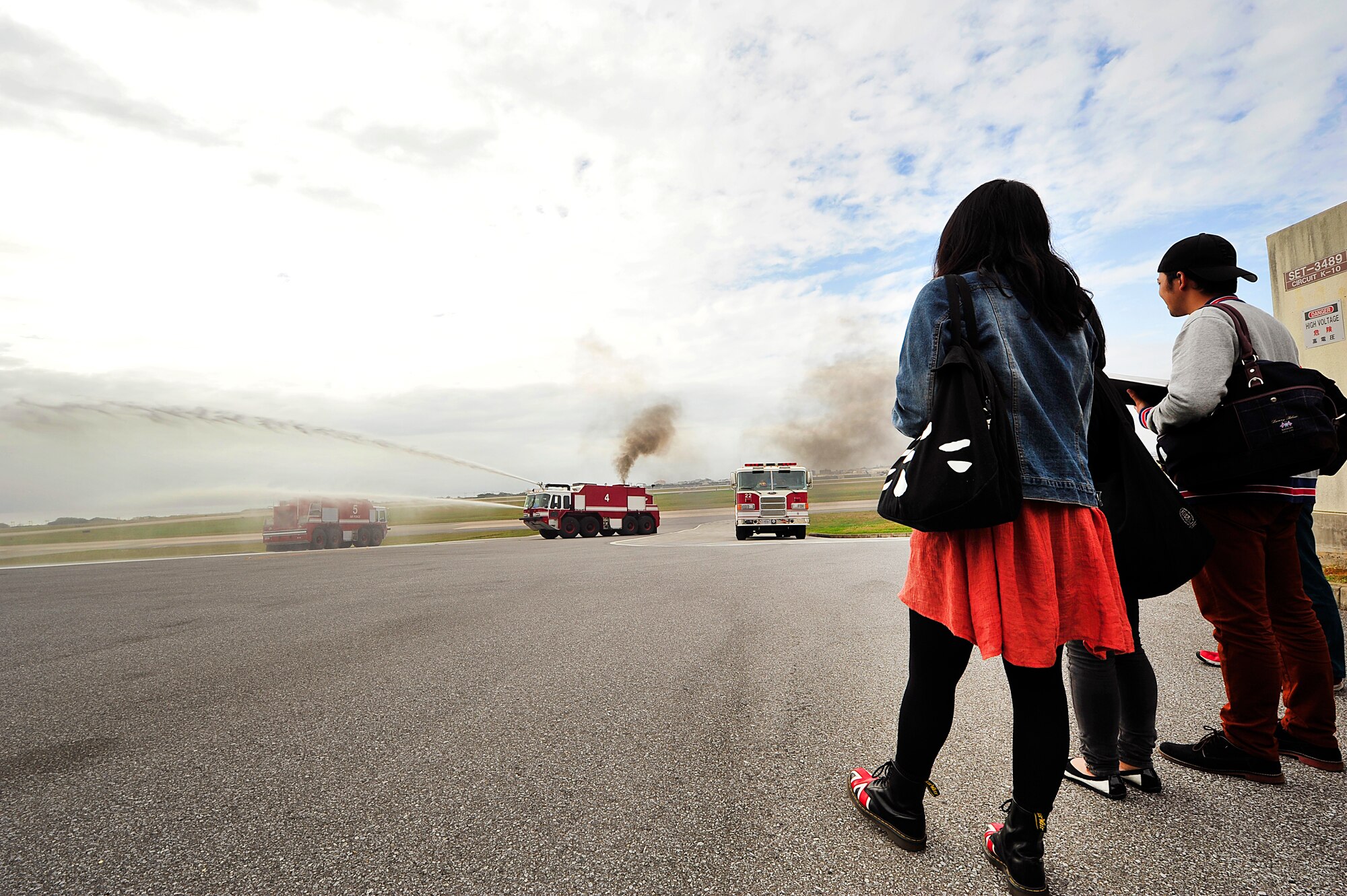 Students from the Okinawa International University watch a fire truck demonstration on Kadena Air Base, Japan, Feb. 23, 2015. During this visit, students learned some of the differences between U. S. military and Japanese disaster prevention measures. (U.S. Air Force photo by Naoto Anazawa)

