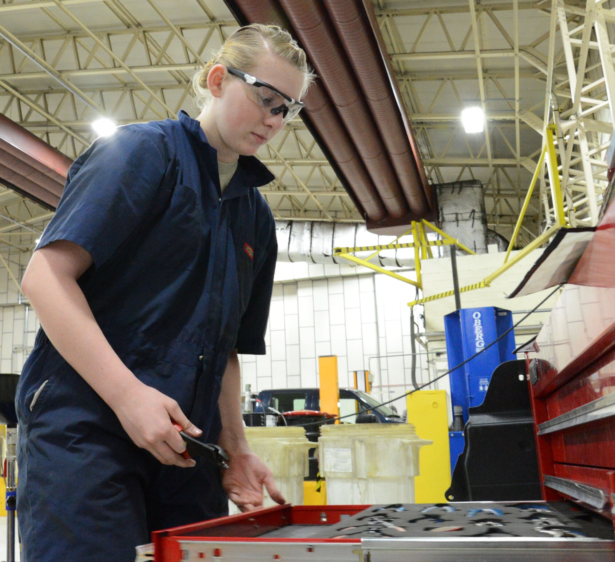U.S. Air Force Airman 1st Class Carly Reuter, 100th Logistics Readiness Squadron Vehicle Maintenance journeyman from Grangeville, Idaho, selects the correct wrench in order to perform a brake test on a government vehicle Feb. 4, 2015, on RAF Mildenhall, England. Reuter is one of the few female mechanics in her shop and she doesn’t let the stereotype of most mechanics being male affect her work ethic. (U.S. Air Force photo by Gina Randall/Released)