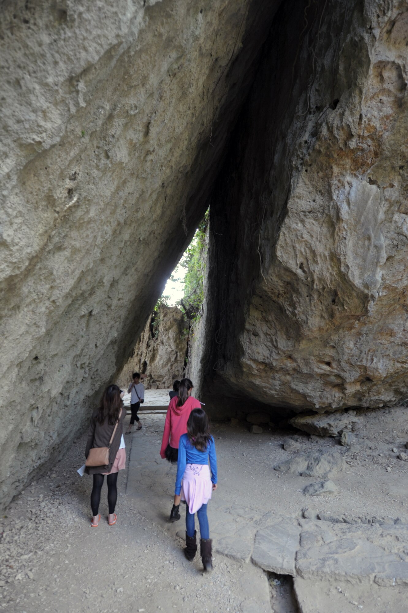 Tourists walk through a v-shaped tunnel formed by two gigantic rock formations at Sefa-Utaki, one of the most significant religious sites on Okinawa, Japan, during a Feb. 21, 2015, visit. The site, about a one-hour drive from Kadena Air Base, offers a great day trip for those looking to explore the island. (U.S. Air Force photo by Tim Flack)