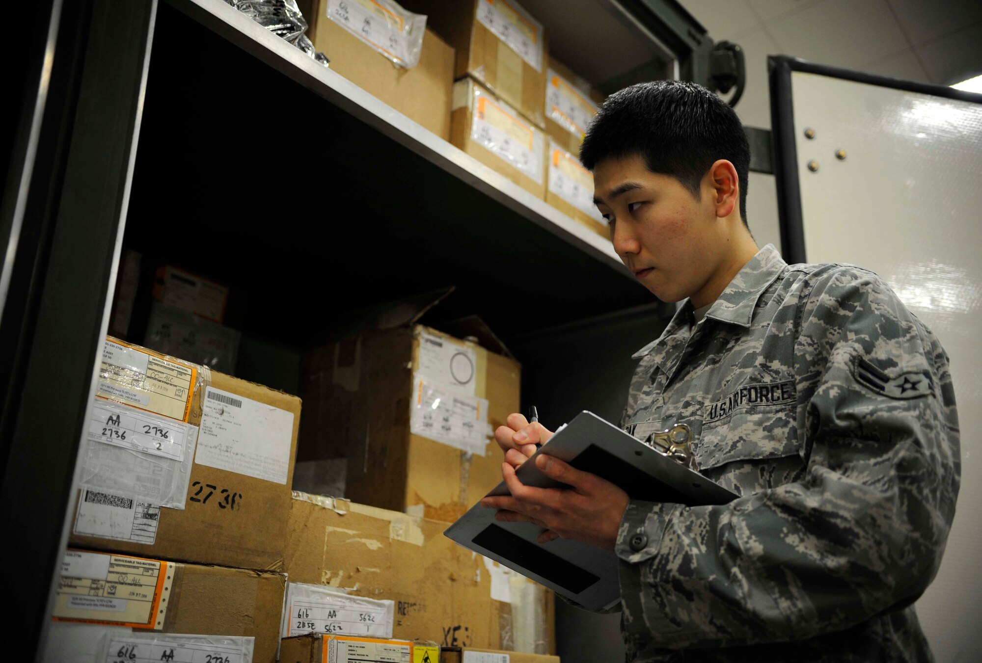 U.S. Air Force Airman 1st Class Christian Pak, materiel management journeyman, checks a serial number on equipment in the aircraft parts store at Misawa Air Base, Japan, Feb. 24, 2015. Pak does this regularly to ensure proper monetary accounting and inventory stock control. (U.S. Air Force photo by Airman 1st Class Jordyn Rucker/Released)
