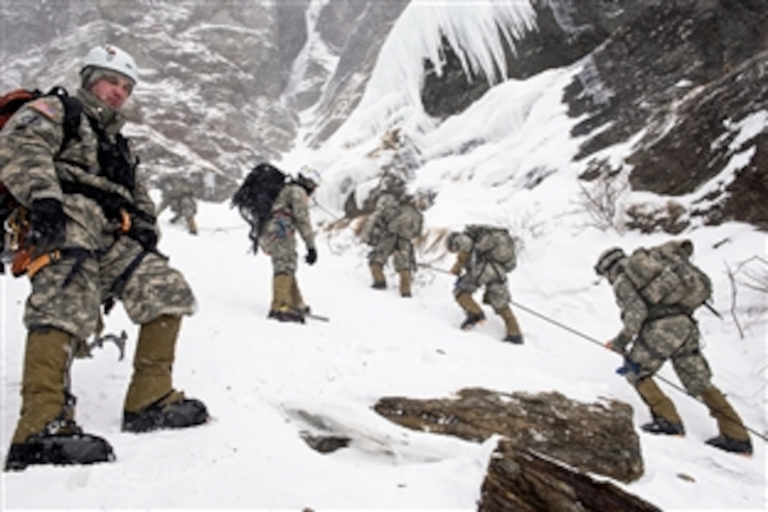 Army Capt. Jason Beams observes soldiers climbing Smugglers' Notch during their final phase of the Basic Military Mountaineering course in Jeffersonville, Vt., Feb. 19, 2015. Beams is the training division officer at the Army Mountain Warfare School in Jericho, Vt. 
