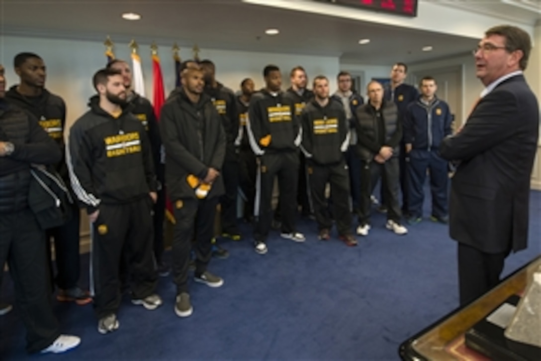 Defense Secretary Ash Carter greets the Golden State Warriors NBA team in his office at the Pentagon, Feb. 25, 2015. 