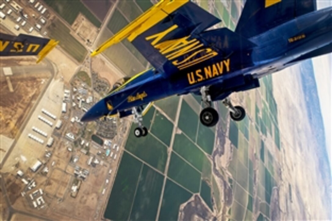 Navy Lt. Matt Suyderhoud, a pilot with the Blue Angels, flies in formation during a practice demonstration with the Diamond pilots over Naval Air Facility El Centro in El Centro, Calif., Feb. 21, 2015. Pilots with the Blue Angels, the Navy's flight demonstration squadron, are training to complete 120 practice flights before kicking off the 2015 show season. 