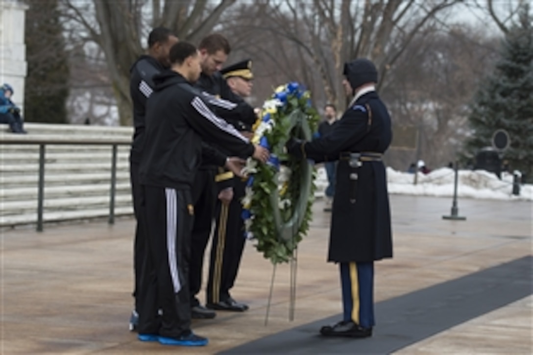 Army Maj. Gen. Jeffrey S. Buchanan and Golden State Warriors NBA team members David Lee, Andre Iguodala and Stephen Curry lay a wreath at the Tomb of the Unknown Soldier at Arlington National Cemetery in Arlington, Va., Feb. 25, 2015, as part of "Commitment to Service," the Defense Department's partnership with the NBA.