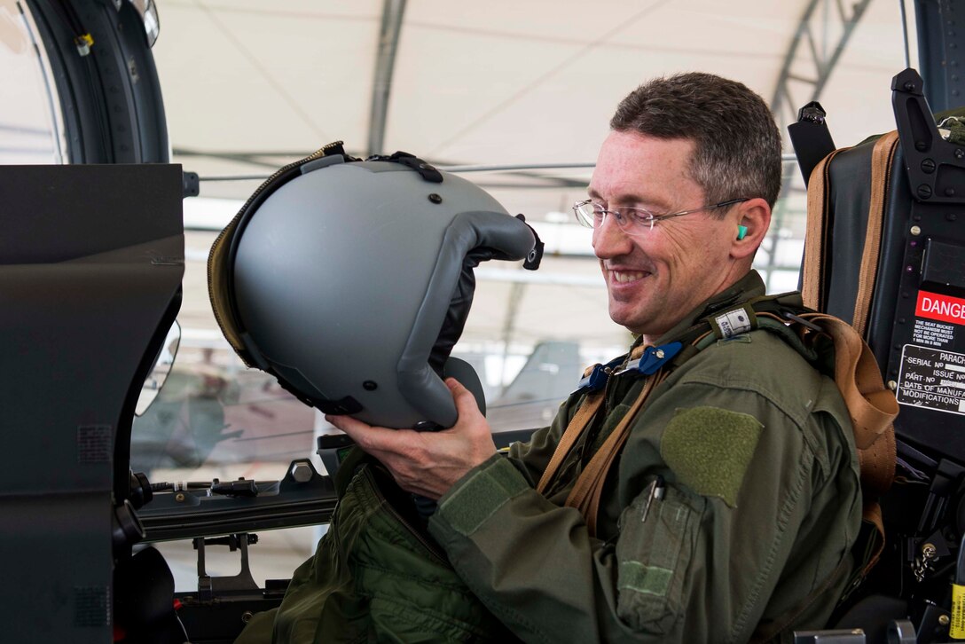 U.S. Air Force Brig. Gen. Michael Rothstein,  Train, Advise, Assist Command-Air commanding general, puts on his flight helmet before flying in an A-29 Super Tucano  Feb. 23, 2015, at Moody Air Force Base, Ga. The A-29, the newest aircraft in the Afghan Air Force arsenal, will add an additional aerial fires capability to the burgeoning air force.  TAAC-Air is charged with readying the Afghan Air Force to defend its country as coalition forces drawdown.  (U.S. Air Force photo by Airman 1st Class Dillian Bamman/Released)