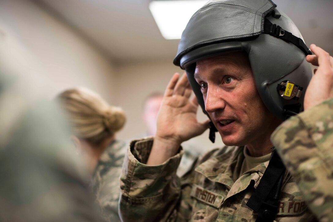 U.S. Air Force Brig. Gen. Michael Rothstein, Train, Advise, Assist Command-Air commanding general, tries on a flight helmet at the 81st Fighter Squadron Feb. 23, 2015, at Moody Air Force Base, Ga.  The TAAC-Air mission is to train, advise and assist Afghan partners in developing a professional, capable and sustainable Afghan Air Force. (U.S. Air Force photo by Airman 1st Class Dillian Bamman/Released)