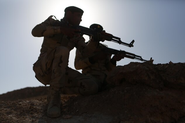 An Iraqi squad leader assigns a soldier his area of responsibility during defense training aboard Al Asad Air Base, Iraq, Feb. 08, 2015. The training gave the soldiers a greater understanding of basic ambush and defense maneuvers. (U.S. Marine photo by Cpl. Will Perkins/RELEASED)