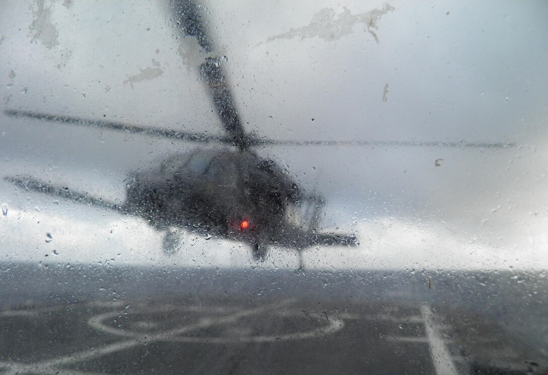 Air Force Reservists from the 920th Rescue Wing, Patrick Air Force Base, Fla., conduct shipboard operations with an HH-60G Pave Hawk helicopter 60 miles off the coast of Mayport, Fla., Dec. 7, 2012. The USS Philippine Sea CG-58 landings qualified the aircrew to land onboard single-spot ships. (File photo) 
     