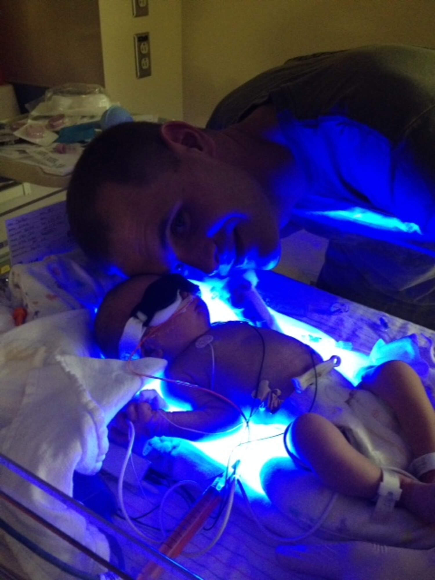Staff Sgt. Phillip Steffen of the 434th Civil Engineering Squadron at Grissom Air Reserve Base, Indiana, poses for a photo with his daughter in the neonatal intensive care unit at Lutheran Hospital in Ft. Wayne, Indiana after meeting her for the first time July 22, 2014. Steffen, the assistant noncommissioned officer in charge of the structures shop at the 434th CES, arrived home from deployment 25 hours after his daughter was born. (Courtesy photo)