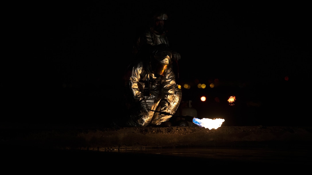 Sgt. Dallas S. Liebe uses a blowtorch to ignite the training pit on Marine Corps Air Station Futenma Feb. 21 during live-burn training. Marines worked together to control and extinguish the fire while enhancing communication and teamwork. Liebe is a Fall City, Washington, native and an assistant section leader with ARFF, H&HS, MCAS Futenma. 