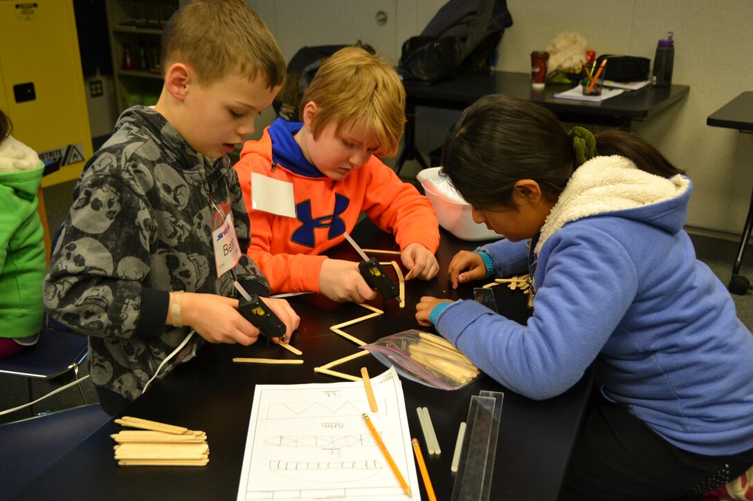 WINCHESTER, Va. - The 4th grade members of STARBASE Team Echo eagerly begin construction of their bridge following their carefully drawn out plans. 