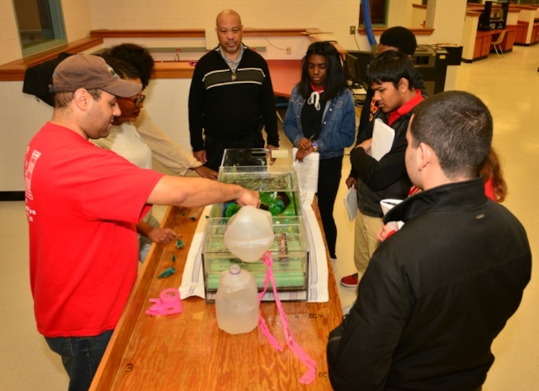 Regulatory Division members demonstrate their flood plains model at Jenkins High School for National Engineer Week Feb. 25. The district partners with the school’s engineering academy to foster interest in the science, technology, engineering, and math fields, also called STEM. This year, students encountered Corps employees holding degrees in a variety of scientific and engineering disciplines. The sample of professions represented a microcosm of the entire workforce whose individual efforts contribute to the Corps’ overall mission (USACE photo by Chelsea Smith).
