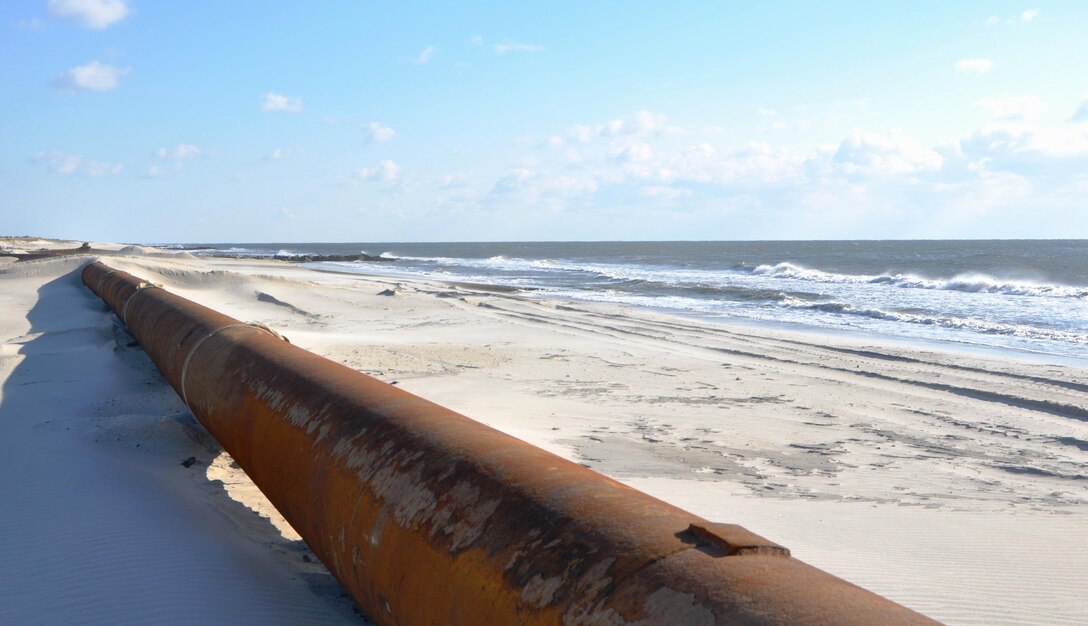 A long pipe spans the coastline at Westhampton Beach, New York, November 21, 2014. The pipe transports a sand and water mixture to shore from an offshore dredge and is then  distributed by bulldozers, helping repair severe erosion caused by Hurricane Sandy in 2012. The Army Corps of Engineers, New York District, placed nearly 1 million cubic yards of sand for the Westhampton Beach Interim Project providing coastal storm risk reduction for nearly 4 miles of shoreline from Westhampton Beach to Cupsogue Beach County Park on Long Island’s south shore. Work included berm and dune restoration, tapering an existing groin, and constructing a new groin. The project was completed in late 2014. 