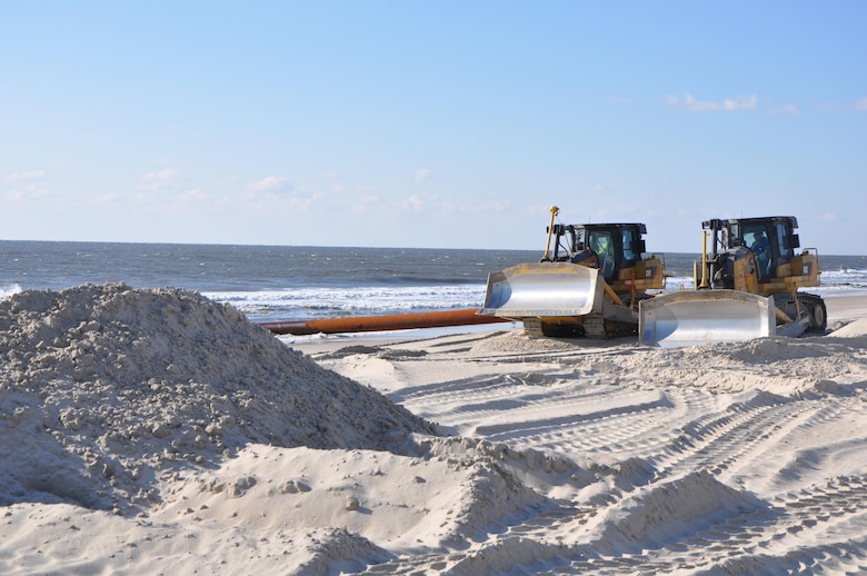 Bulldozers distribute newly-placed sand at Westhampton Beach, New York, November 21, 2014. The sand, pumped onto the beach from an approved offshore borrow site, repaired severe erosion caused by Hurricane Sandy in 2012. The Army Corps of Engineers, New York District, placed nearly 1 million cubic yards of sand for the Westhampton Beach Interim Project providing coastal storm risk reduction for nearly 4 miles of shoreline from Westhampton Beach to Cupsogue Beach County Park on Long Island’s south shore. Work included berm and dune restoration, tapering an existing groin, and constructing a new groin. The project was completed in late 2014. 