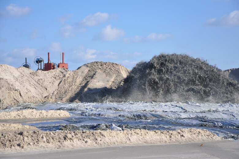 A mixture of sand and water pumping ashore at Westhampton Beach, New York, November 21, 2014, repairing significant erosion caused by Hurricane Sandy in 2012. The Army Corps of Engineers, New York District, placed nearly 1 million cubic yards of sand for the Westhampton Beach Interim Project providing coastal storm risk reduction for nearly 4 miles of shoreline from Westhampton Beach to Cupsogue Beach County Park on Long Island’s south shore. Work included berm and dune restoration, tapering an existing groin, and constructing a new groin. The project was completed late 2014. 