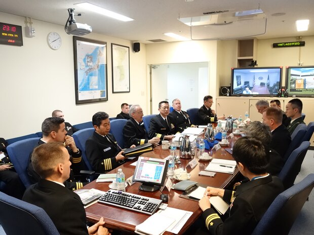 OKINAWA, Japan (Feb 24, 2015) - Rear Adm. Hugh D. Wetherald, Commander, Amphibious Force Seventh Fleet, Rear Adm. Hiroshi Oka, Commander, Mine Warfare Force, Japanese Maritime Self Defense Force (JMSDF), and CAPT. Mike Dowling Commander, Mine Countermeasures Squadron (MCMRON) 7 discuss amphibious and mine warfare during the annual Mine Warfare Staff Talks hosted at Amphibious Force Seventh Fleet Headquarters in White Beach, Okinawa. This year's conference highlighted an increased focus on enhancing combined exercises to better integrate U.S. and Japanese forces and capabilities on a live-force environment. 