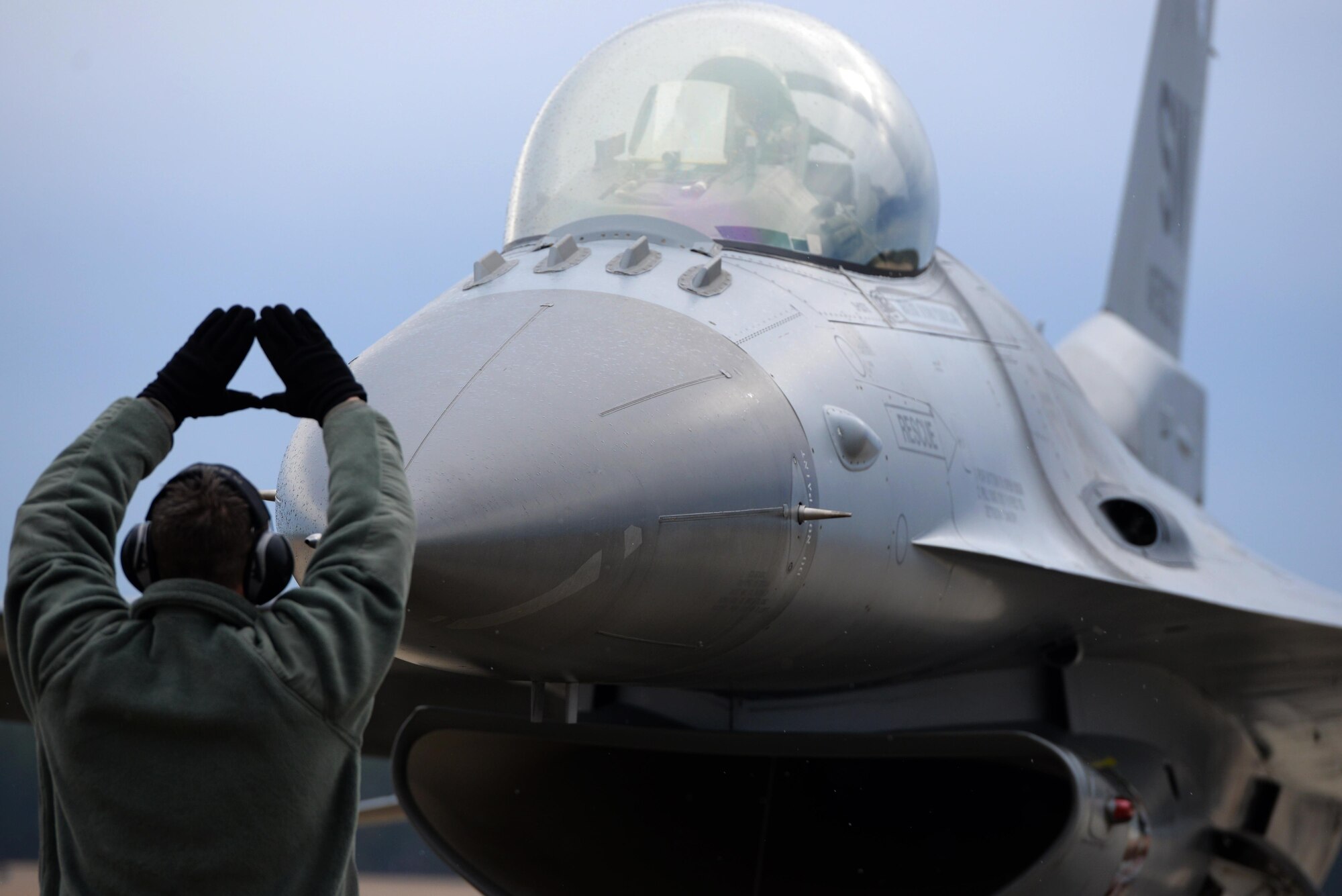 An Airman marshals an F-16 Fighting Falcon to a stop Feb. 5, 2015, at Shaw Air Force Base, S.C. The mission of the 20th Fighter Wing is to provide combat ready airpower and Airmen, to meet any challenge, anytime, anywhere. The Airman is assigned to the 20th Aircraft Maintenance Squadron. (U.S. Air Force photo/Airman 1st Class Jonathan Bass)