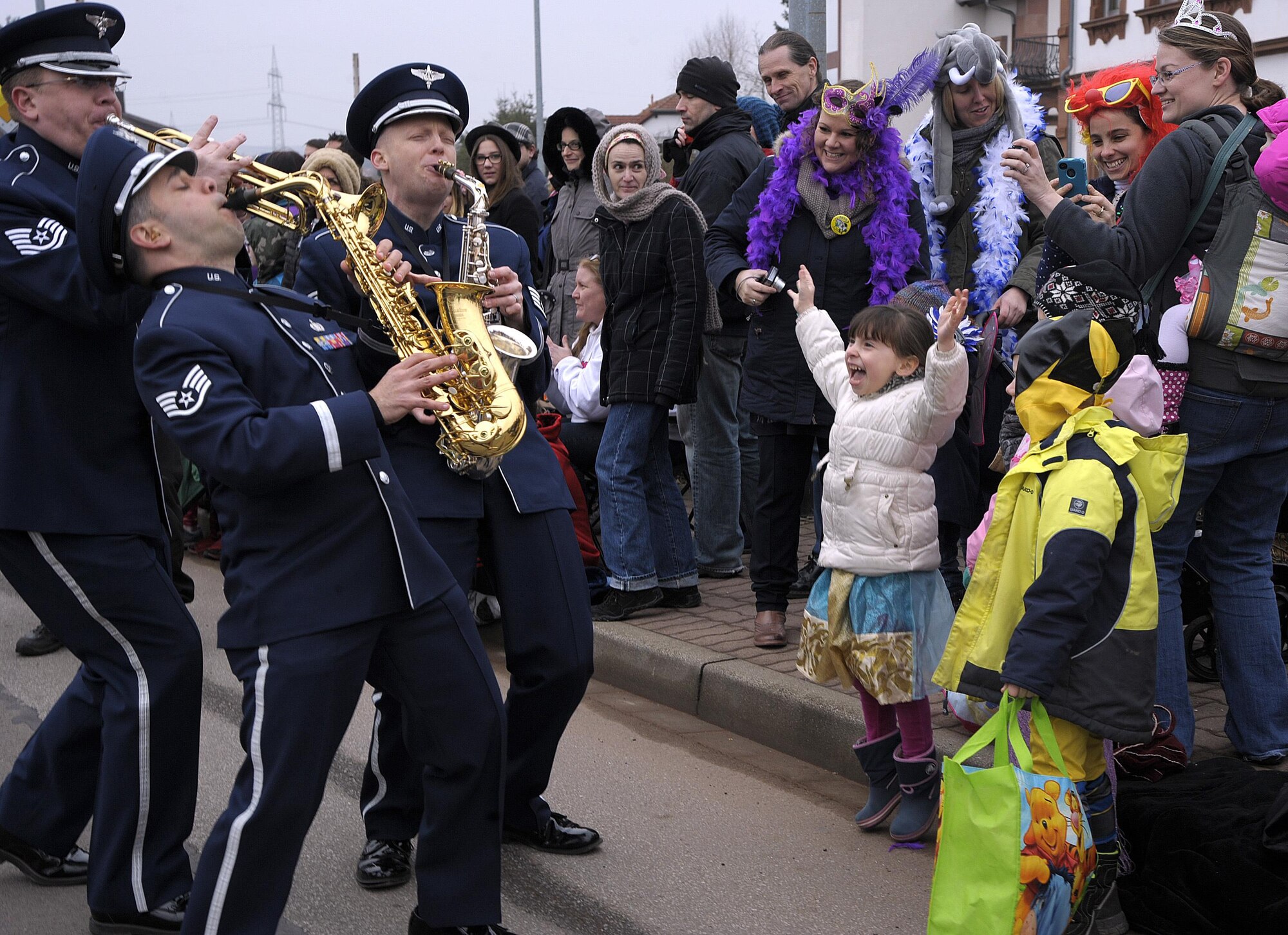 Members of the U.S. Air Forces in Europe Band interact with the crowd during the Fasching parade Feb. 17, 2015, in Ramstein-Miesenbach, Germany. The USAFE Band and approximately 1,400 other participants marched in the parade for more than two hours, entertaining the crowd. (U.S. Air Force photo/Senior Airman Timothy Moore)     