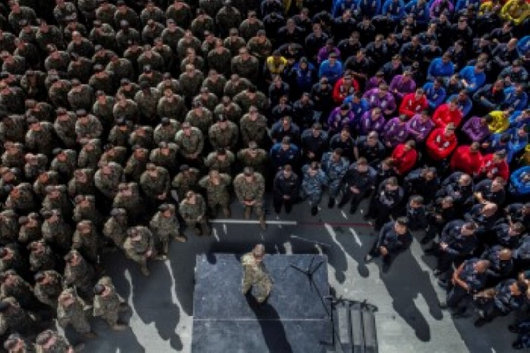 U.S. Marine Maj. Gen. Carl E. Mundy III, middle,  speaks  to Marines and Sailors aboard the USS Essex (LHD 2) during Amphibious Squadron/Marine Expeditionary Unit Integration Training (PMINT) at sea Feb. 26, 2015. Mundy is the commander, Task Force 51. Mundy spoke to the Marines and sailors of the 15th Marine Expeditionary Unit and Essex Amphibious Ready Group about the importance of working together as a blue/green team during their upcoming deployment. (U.S. Marine Corps photo by Cpl. Steve H. Lopez/Released)