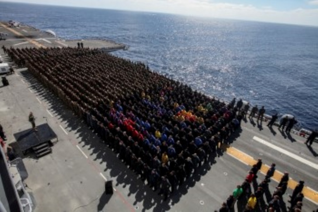 U.S. Marines and Sailors await Maj. Gen. Carl E. Mundy III to speak aboard the USS Essex (LHD 2) during Amphibious Squadron/Marine Expeditionary Unit Integration Training (PMINT) at sea Feb. 26, 2015. Mundy is the commander, Task Force 51. Mundy spoke about the future missions the 15th MEU may encounter while forward deployed. The 15th MEU will fall under Task Force 51 while deployed to the CENTCOM area of responsibility.  (U.S. Marine Corps photo by Cpl. Steve H. Lopez/Released)