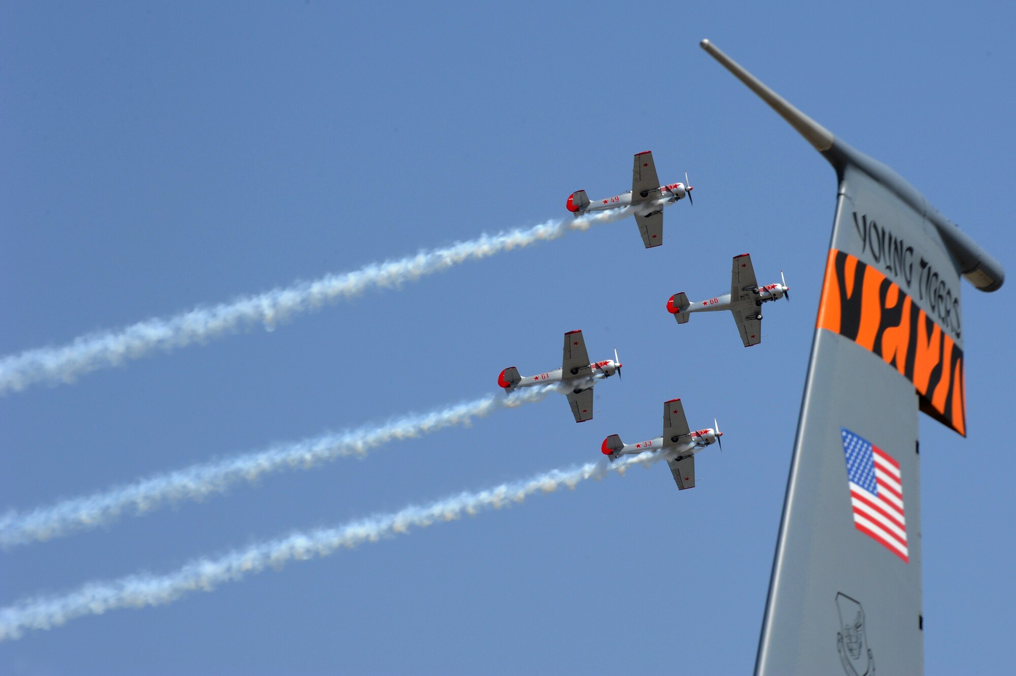 Members with Indian Army's 2nd Parachute Regiment (Special Forces), and National Security Guard jump from a Pacific Air Forces C-17 Globemaster III for a parachuting demonstration at Air Force Station Yelahanka, Bengaluru, India, Feb. 20, 2015. Aero India is India's premier aerospace exhibition and airshow and allows the United States to demonstrate its commitment to the security of the Indo-Asia-Pacific region and showcase defense aircraft and equipment, which ultimately contributes toward better regional cooperation and tactical compatibility with other countries.  This year marks the 10th iteration of Aero India since its inception in 1996.  (U.S. Air Force photo by Airman 1st Class Stephen G.Eigel/Released)