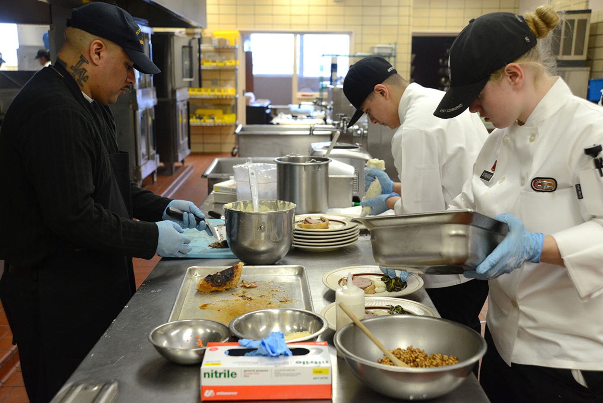 The team dubbed 'Team Alaska' had to work together for the main course; a Beef Wellington topped with a green peppercorn sauce, with a side of herbed mashed potatoes and warm wilted green salad, served at the Kenai Dining Hall, JBER on Feb. 20, 2015. The 10-person team of Soldiers and Airmen tried to make a five-star three-course meal from an Army field kitchen for JBER leadership to prepare for 40th Annual Military Culinary Arts Competitive Training Event at Fort Lee, VA. March 4-13. (Air Force photo/Airman Christopher R. Morales)