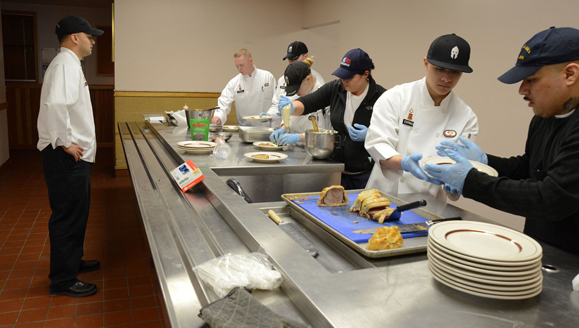 The team dubbed 'Team Alaska' had to work together for the main course; a Beef Wellington topped with a green peppercorn sauce, with a side of herbed mashed potatoes and warm wilted green salad, served at the Kenai Dining Hall on Feb. 20, 2015. The 10-person team of Soldiers and Airmen tried to make a five-star three-course meal from an Army field kitchen for JBER leadership to prepare for 40th Annual Military Culinary Arts Competitive Training Event at Fort Lee, VA. March 4-13. (Air Force photo/Airman Christopher R. Morales)