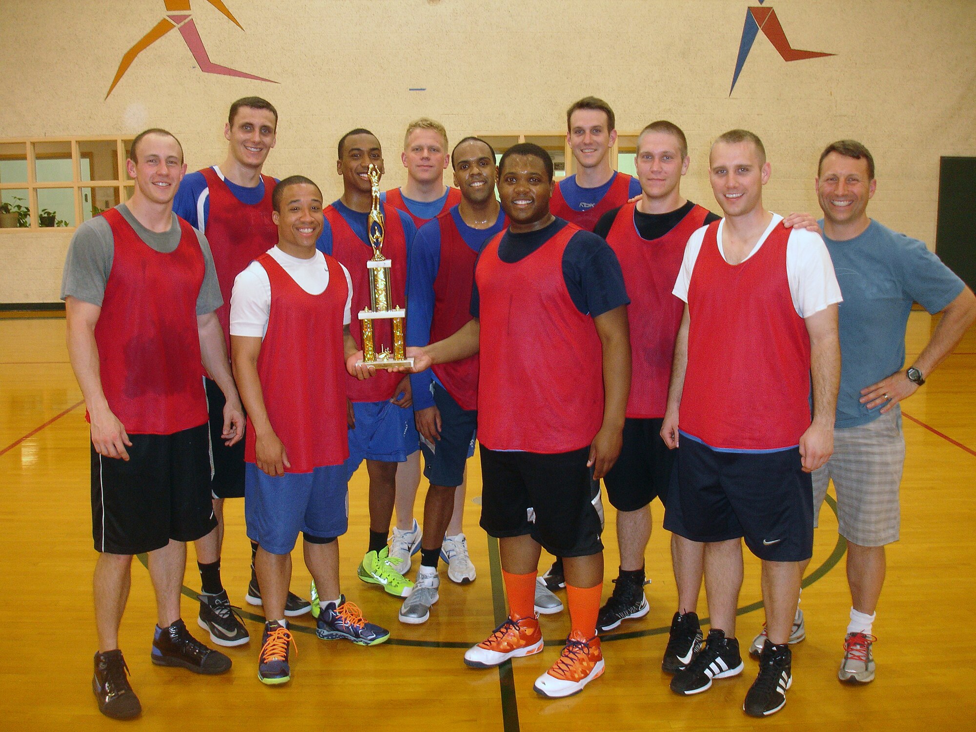 The 2014 71st Student Squadron celebrates with their Championship Trophy at the  Bradley Fitness and Sports Center. (U.S. Air Force Photo/David Poe)