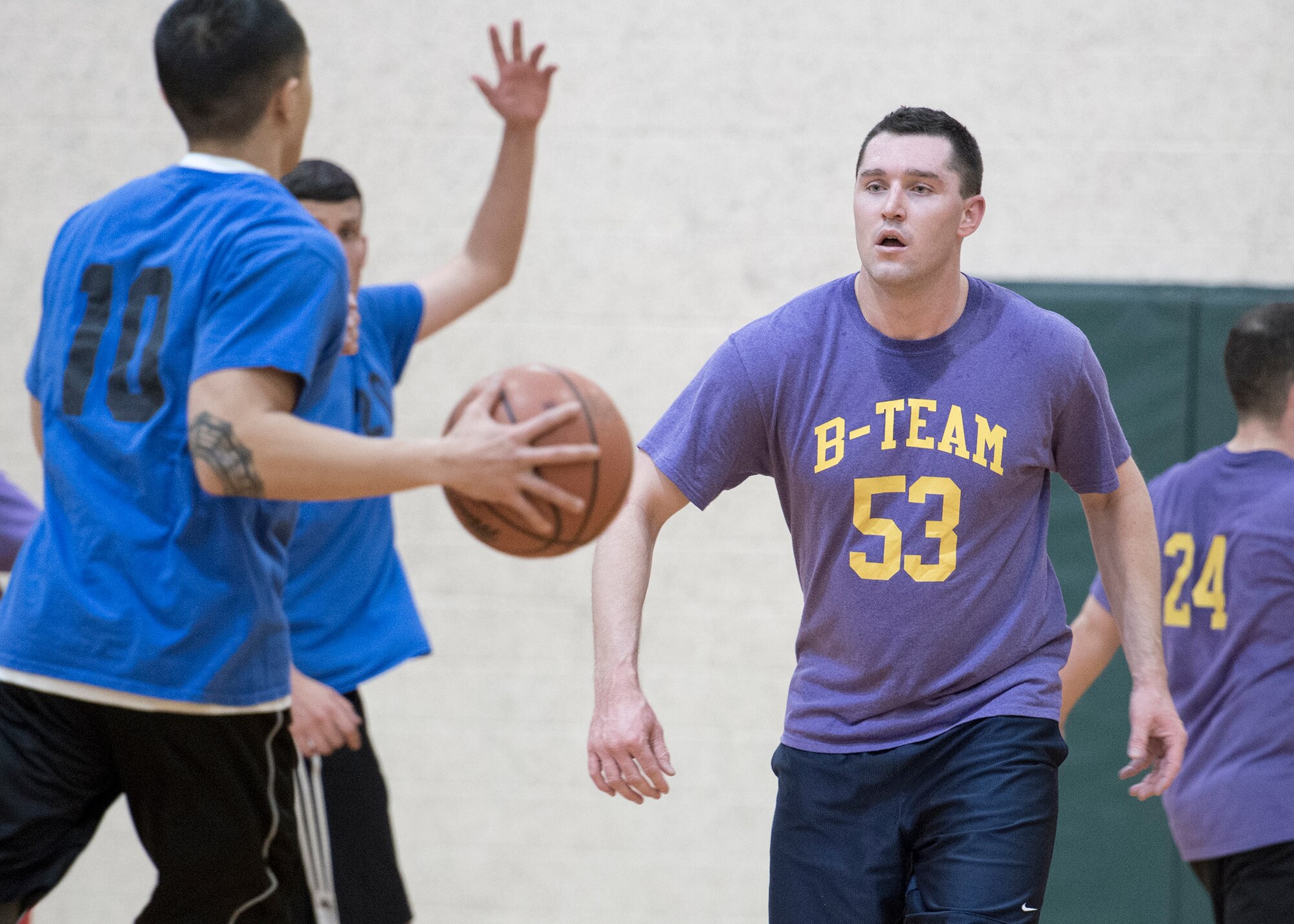 VANCE AIR FORCE BASE, Okla. -- 71st Student Squadron's Eddie Lacy eyes a ballcarrier during a hoops game at Bradley Fitness and Sports Center on base, Feb. 12. (U.S. Air Force photo / David Poe)