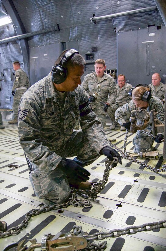 TRAVIS AIR FORCE BASE, Calif. -- 349th Air Mobility Wing members participate in Air Force Specialty Code training Feb.21-22, Travis Air Force Base, Calif. The Aerial Port mission training consisted of aircrew and porters chaining down vehicle cargo, such as a fire truck, inside of a C-5 Galaxy. (U.S. Air Force photos/Senior Airman Madelyn Brown)