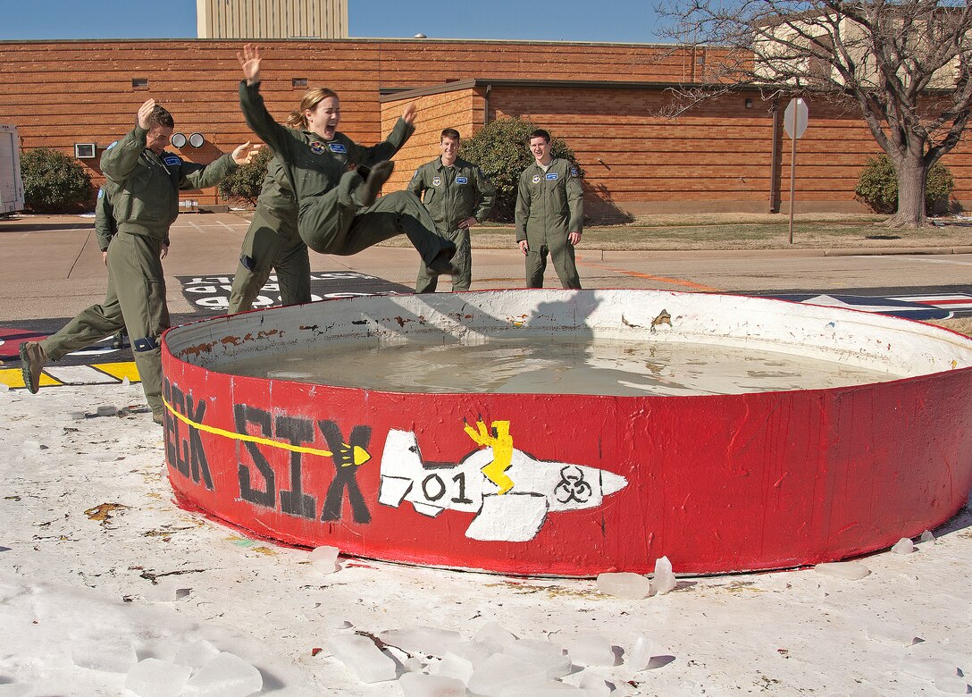 2nd Lt. Brittany Dippel, 80th Flying Training Wing Euro-NATO Joint Jet Pilot Training student, is thrown into a water-filled tank immediately following her solo flight in a T-6 Texan II Feb. 25, 2015, at Sheppard Air Force Base, Texas. The dunk tank is a tradition within the pilot training program celebrating the student's first solo flight in an aircraft.  This is an important milestone for students as they strive to earn their pilot wings.
(U.S. Air Force photo by Danny Webb)
