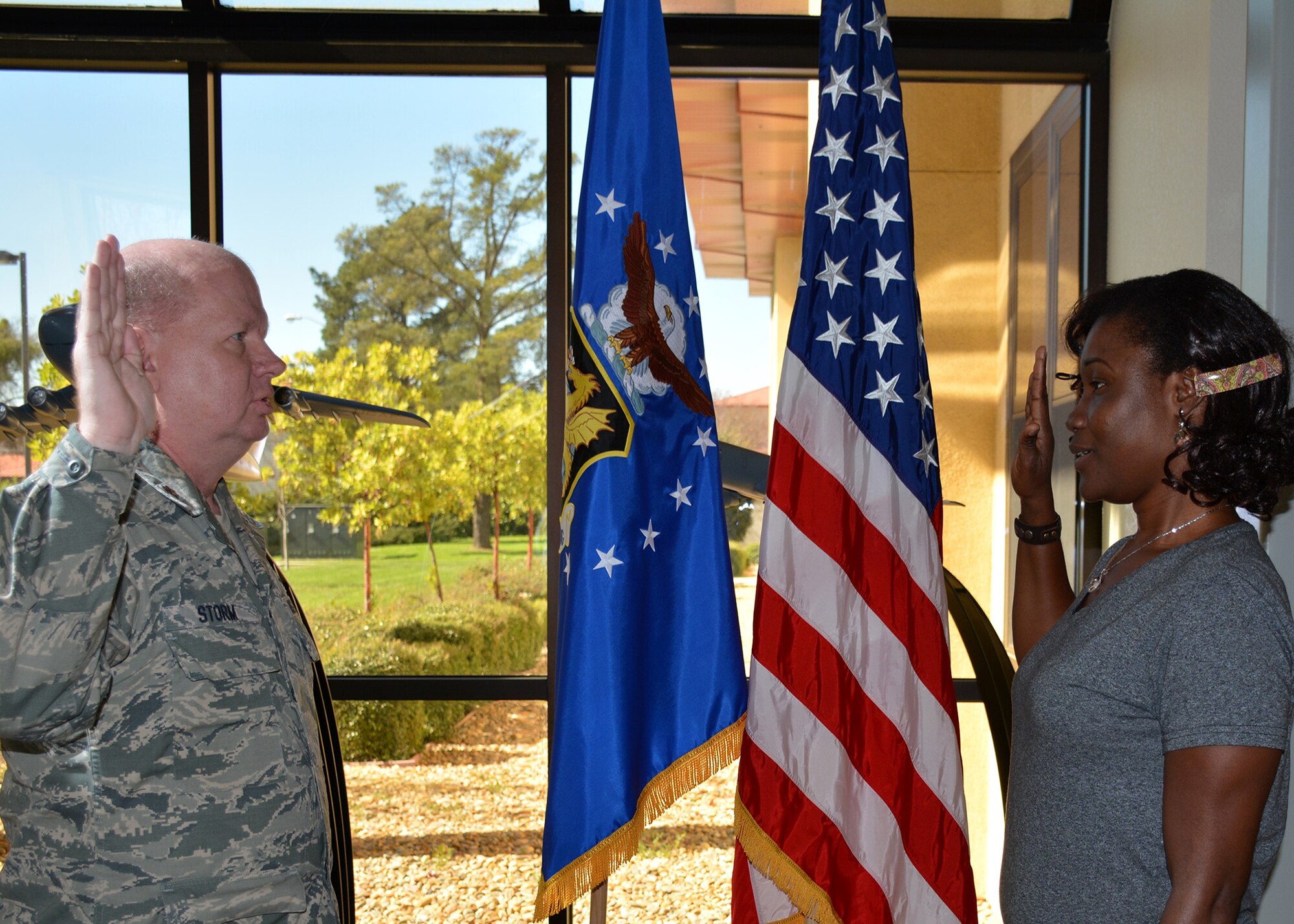 TRAVIS AIR FORCE BASE, Calif. -- Maj. Gordon Storm administers the oath of enlistment to Alexandra Igbineweka, Feb. 24, 2015, in the 349th AMW headquarters foyer. (U.S. Air Force photo/Master Sgt. Robert Thames)