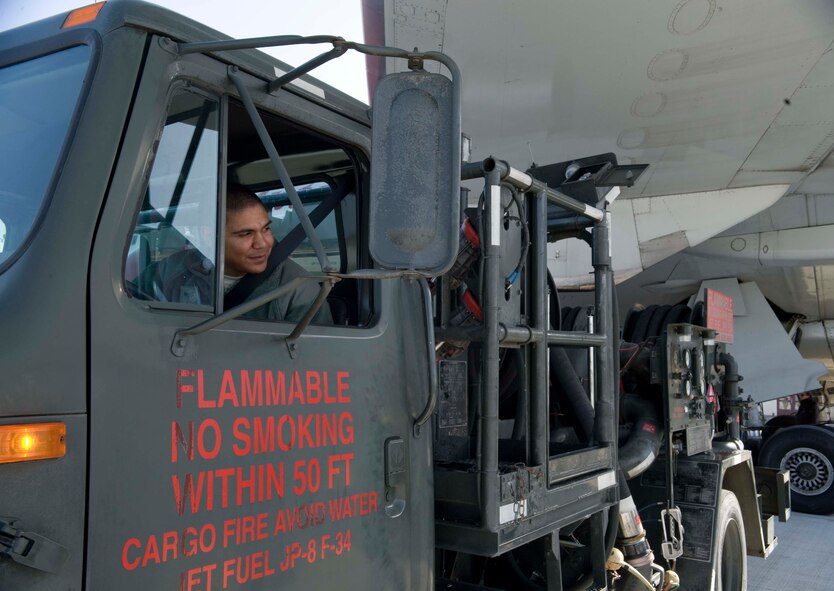 U.S. Air Force Senior Airman Michael Thomas, 35th Logistics Readiness Squadron fuels distribution operator, backs an R-12 fuel servicing vehicle into the correct position to fuel the Patriot Express aircraft at Misawa Air Base, Japan, Feb. 24, 2015. The newly installed Type III constant pressure system requires only one Airman to perform a refuel, whereas the previous system needed up to four, saving time and manpower. (U.S. Air Force photo by Airman 1st Class Jordyn Rucker/Released)