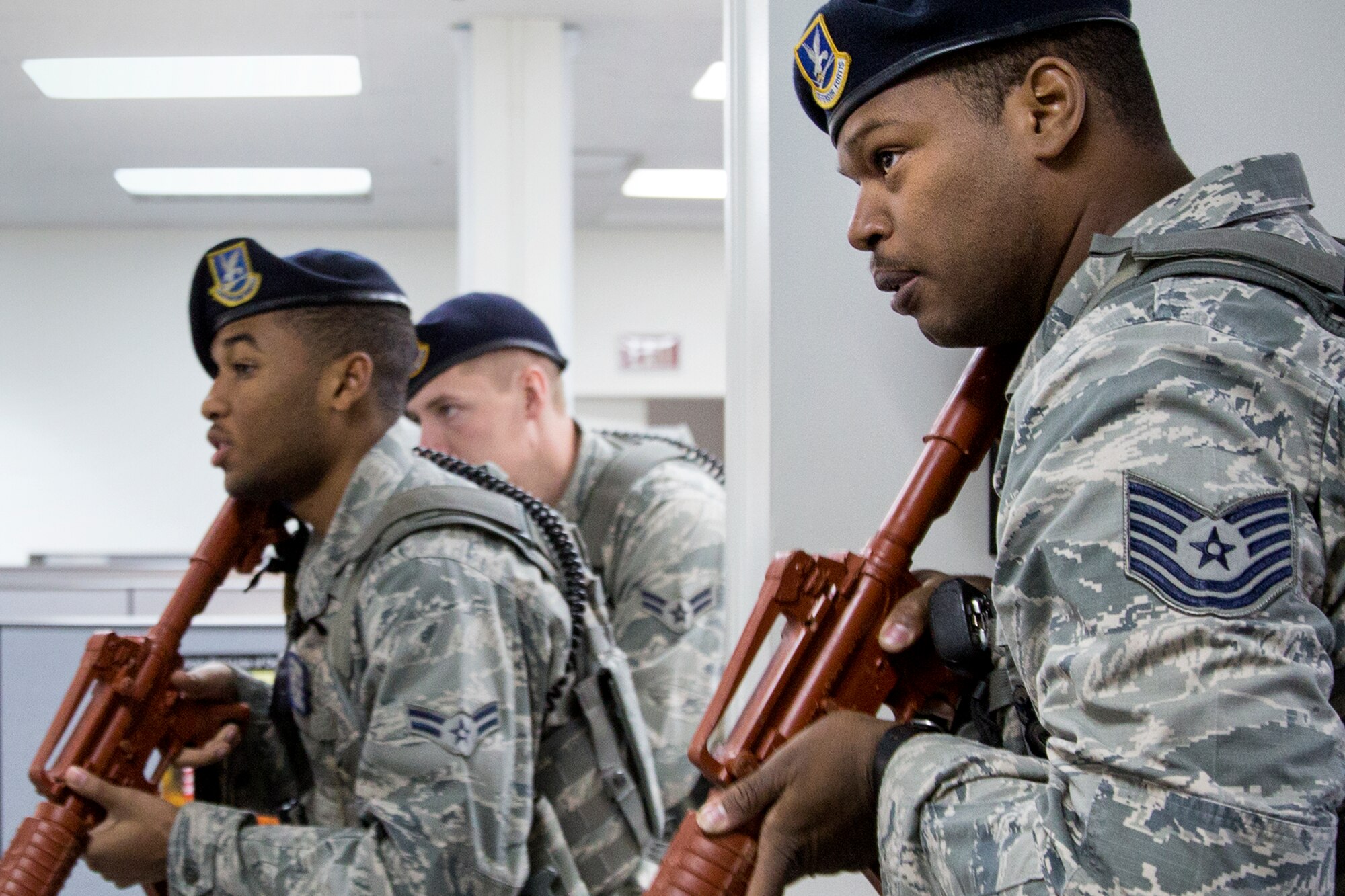 Defenders from the 374th Security Forces Squadron clear the second room of the Defense Finance and Accounting Service Japan facility during an active shooter training scenario at Yokota Air Base, Japan, Feb. 25, 2015. The scenario tested and validated DFAS’ force protection plans, occupant emergency plan, and evacuation and accountability procedures. (U.S. Air Force photo by Osakabe Yasuo/Released)   