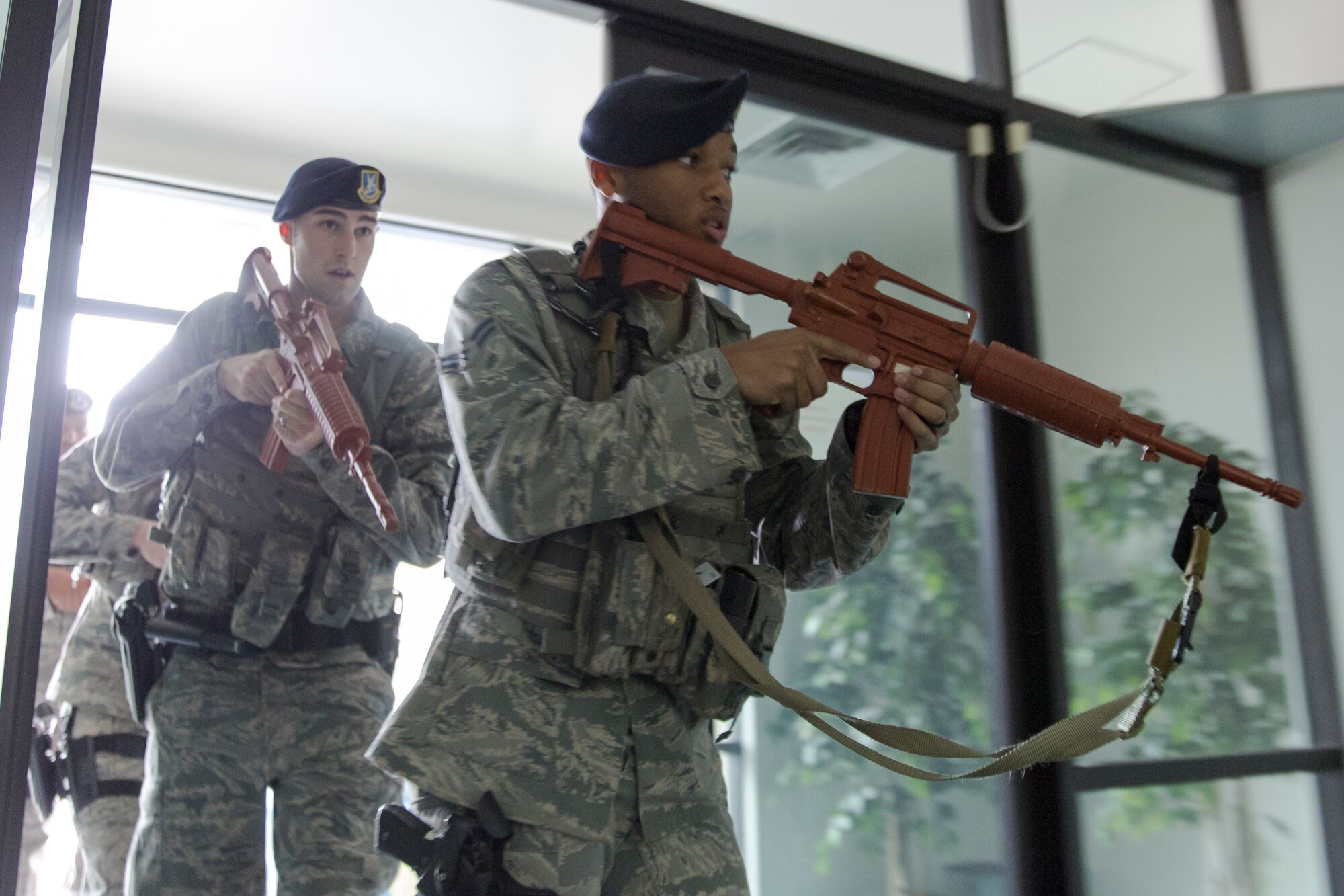 (Front to back) Airman 1st Class Jamal Wilson and Airman 1st Class Jared Paradis, both 374th Security Forces Squadron patrolmen, enter the Defense Finance and Accounting Service Japan facility during an active shooter training scenario at Yokota Air Base, Feb. 25. 2015. The scenario tested and validated DFAS’ force protection plans, occupant emergency plan, and evacuation and accountability procedures. (U.S. Air Force photo by Osakabe Yasuo/Released) 