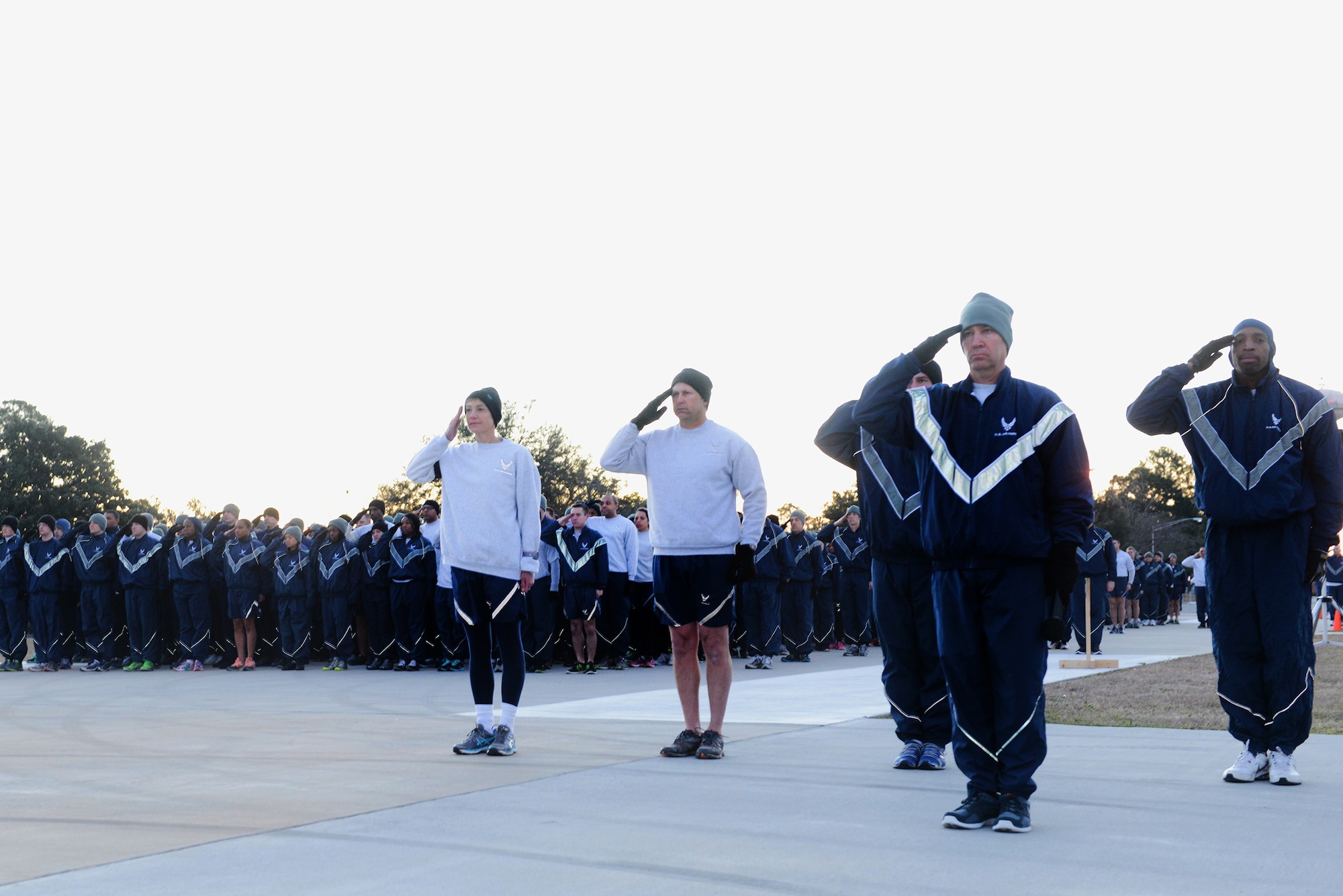 Members of the 23d Wing render salutes for Reveille during Comprehensive Airmen Fitness Day Feb. 20, 2015, at Moody Air Force Base, Ga. Base leadership led the 2.3-mile run to kick off the day. (U.S. Air Force photo by Airman 1st Class Kathleen D. Bryant/Released) 