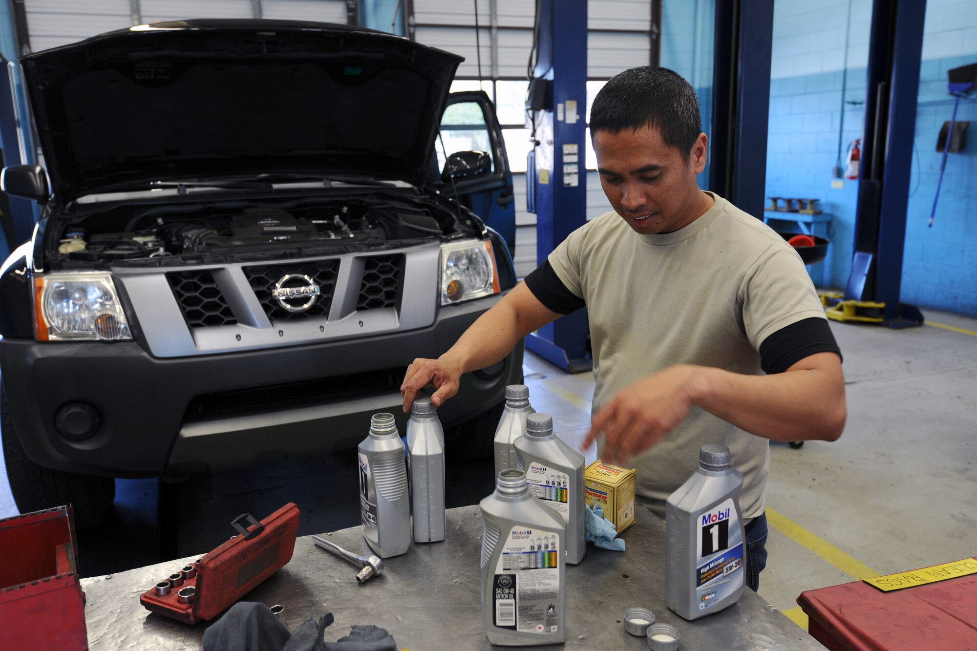 Staff Sgt. Allin Pequit, Air Force Civil Engineer Center airfield pavement technician, prepares to perform an oil change on his vehicle Feb. 20 at the Tyndall Auto Hobby Shop. The Auto Hobby shop allows customers to perform their own maintenance on vehicles. (U.S. Air Force photo by Airman 1st Class Ty-Rico Lea/Released)
 
